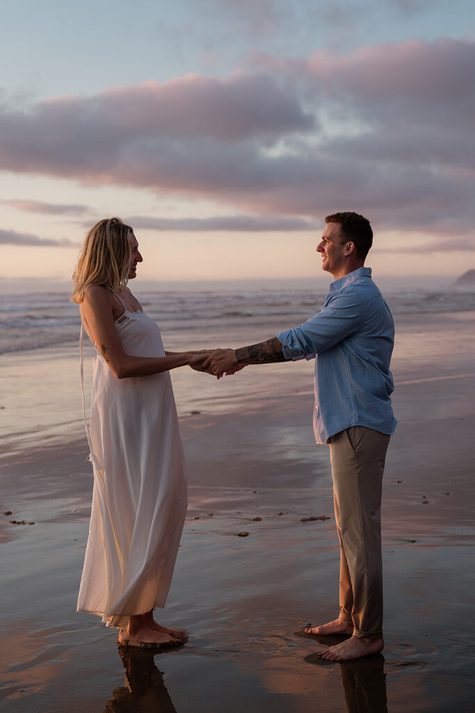 Couple plays around on the Oregon Coast at hug point during their engagement photos