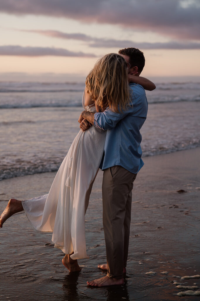 Couple plays around on the Oregon Coast at hug point during their engagement photos