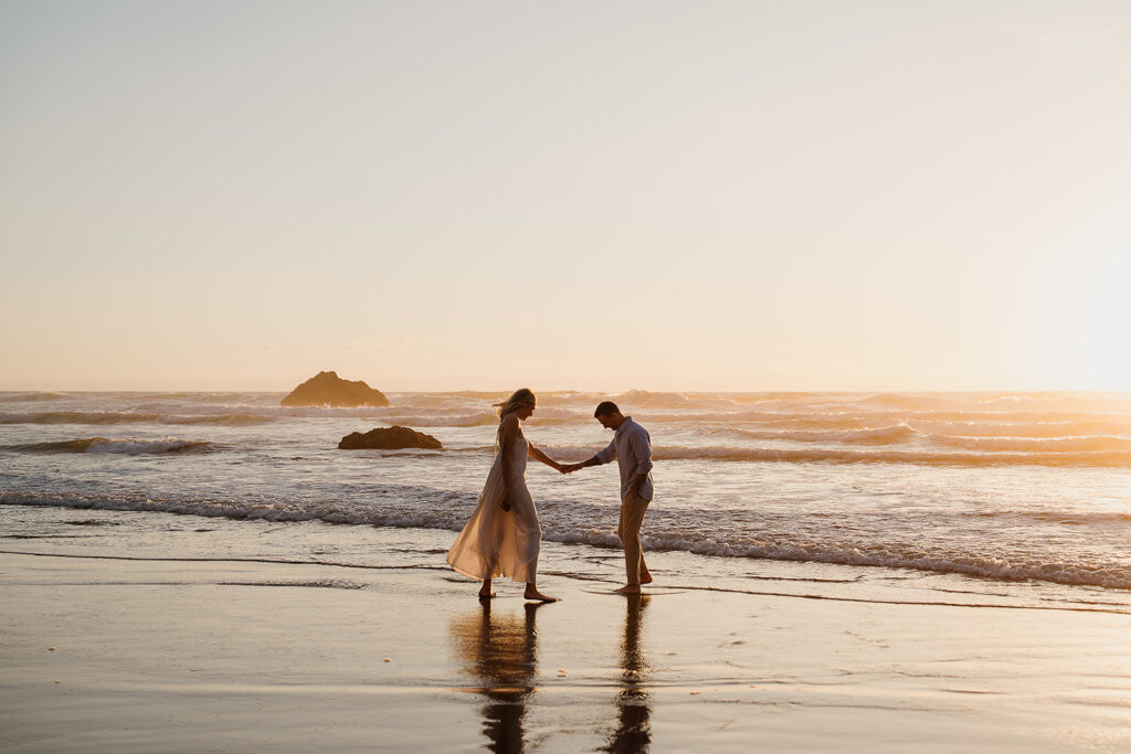 Couple plays around on the Oregon Coast at hug point during their engagement photos