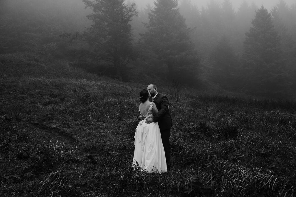 Couple kissing in the misty landscape along the Oregon Coast.