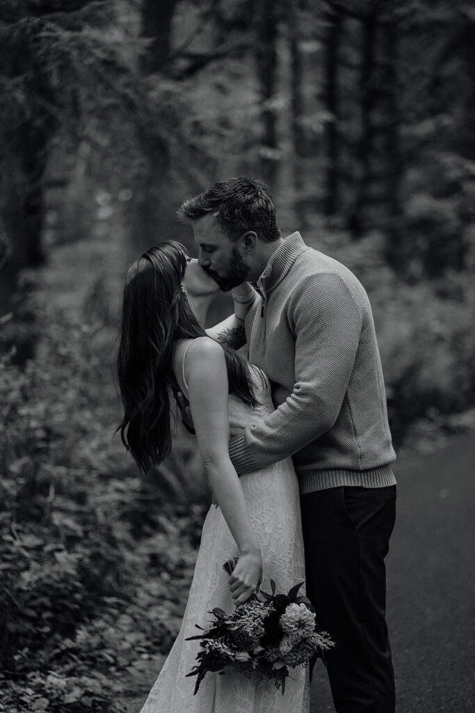 Bride and groom stand in the moody forest of Ecola State Park