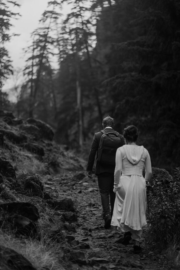 Bride and groom hike to a waterfall for some elopement portraits