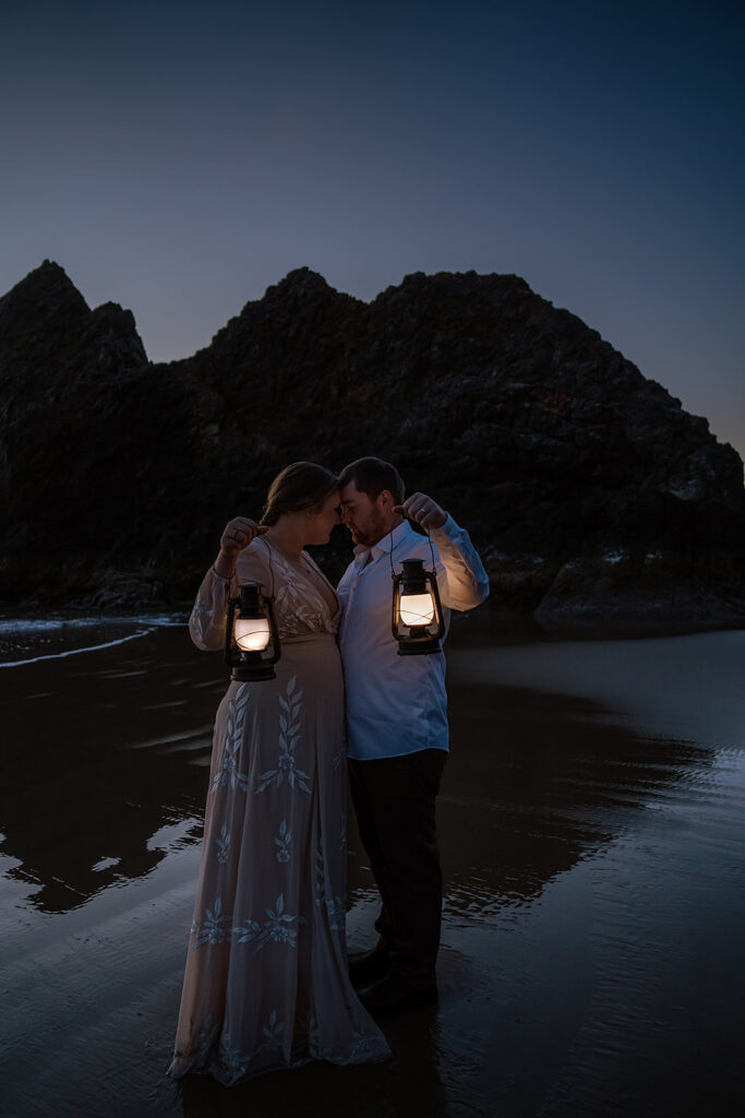 Coastal elopement portraits on Arcadia Beach at dusk with lanterns