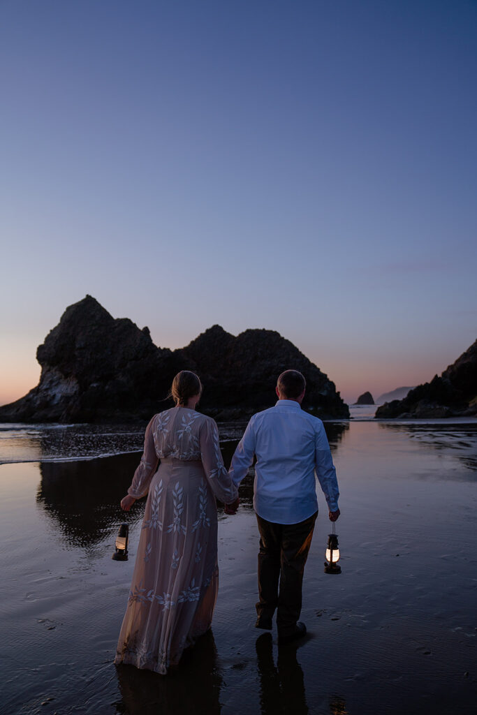 Coastal elopement portraits on Arcadia Beach at dusk with lanterns