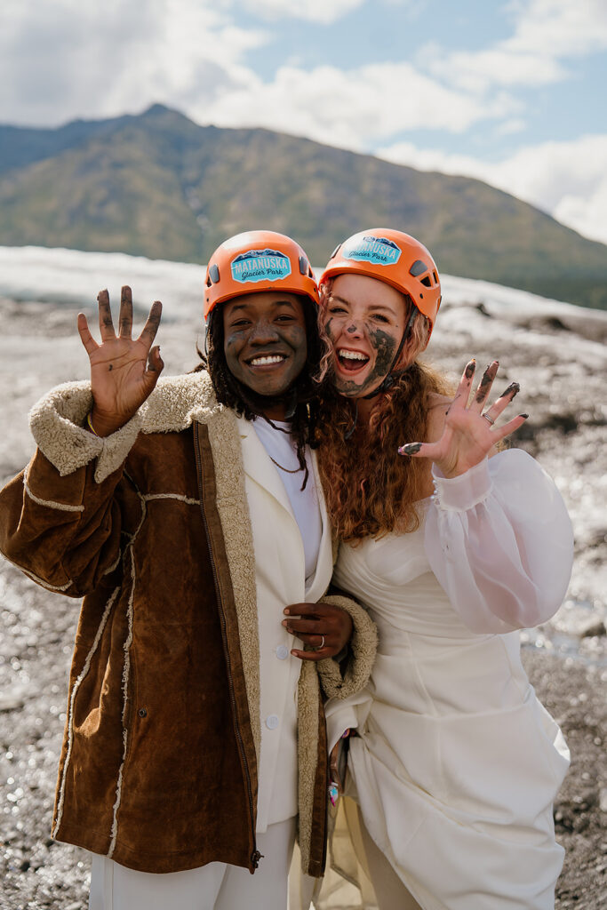 Couple swipes mud on their faces after their glacier elopement ceremony