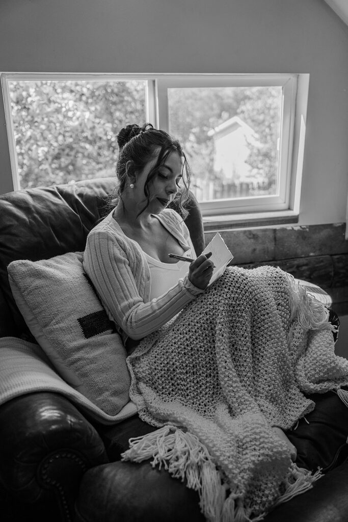Bride writing vows in an Alaska Cabin before ceremony