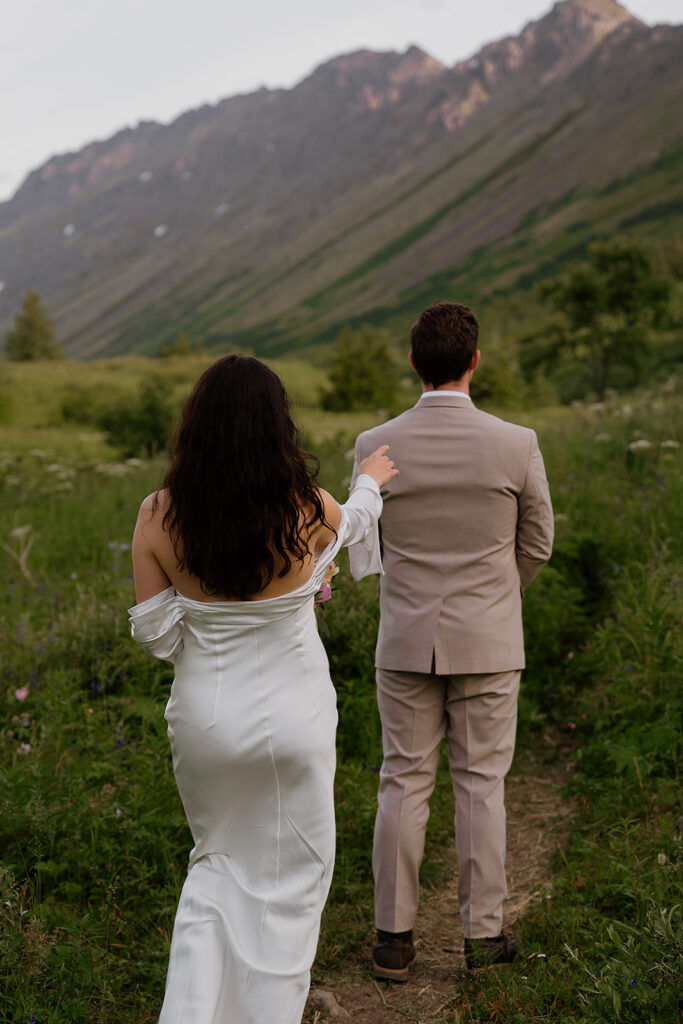 Intimate first look between bride and groom in the mountains during a summer Alaska elopement