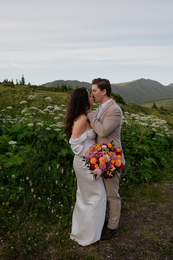 Romantic portraits of bride and groom in golden evening light during their Alaska mountain elopement