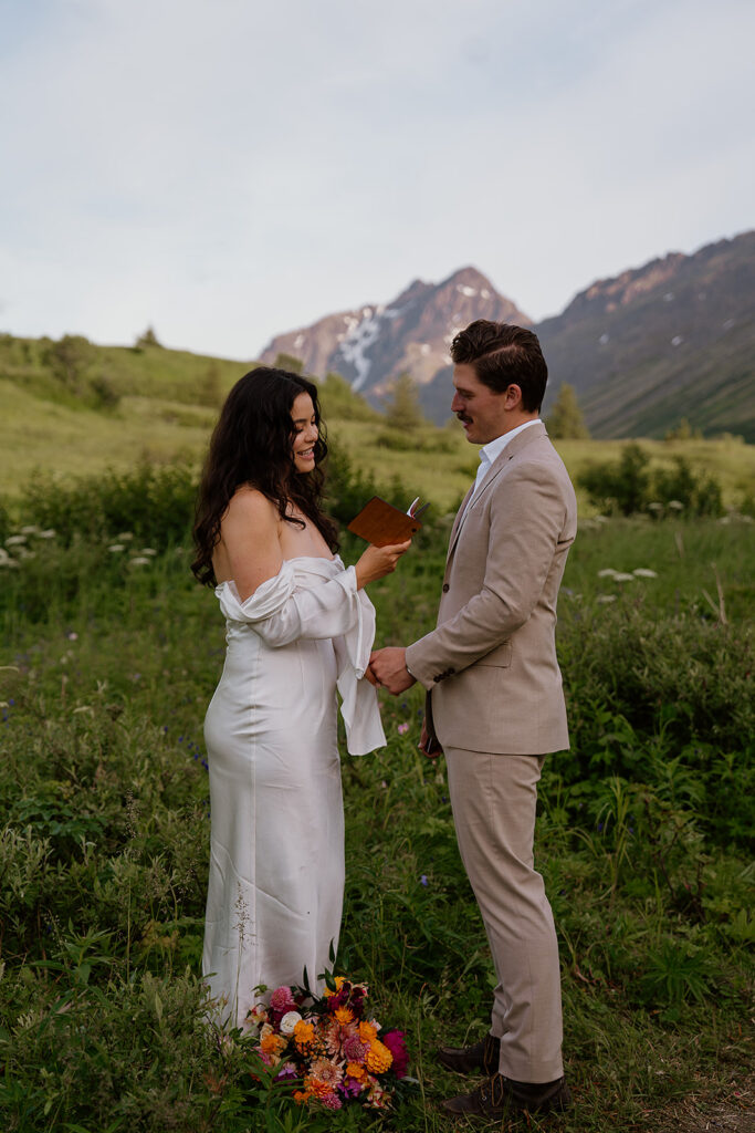 Couple exchanging vows in a quiet alpine meadow at Flattop Mountain in Anchorage Alaska