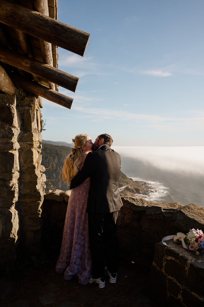Couple kisses at Cape Perpetua