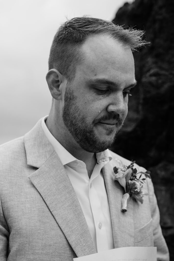 A tear falls from groom's eye as he reads his vows on Arcadia Beach