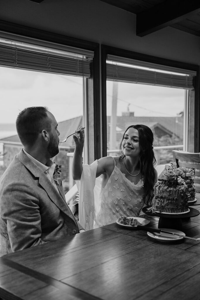 Bride and groom cut their personal cakes after an emotional Cannon Beach wedding ceremony