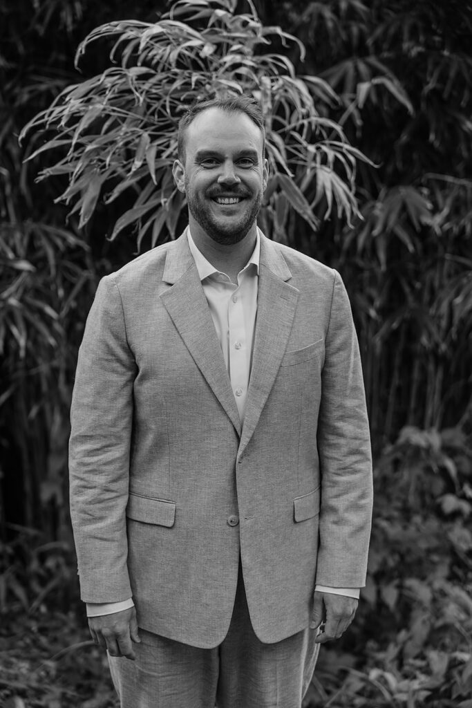 Groom standing and smiling
