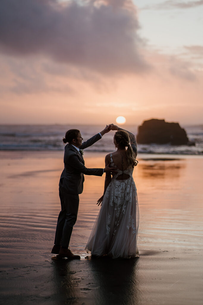 Newlyweds dance on the beach at sunset near Cannon Beach