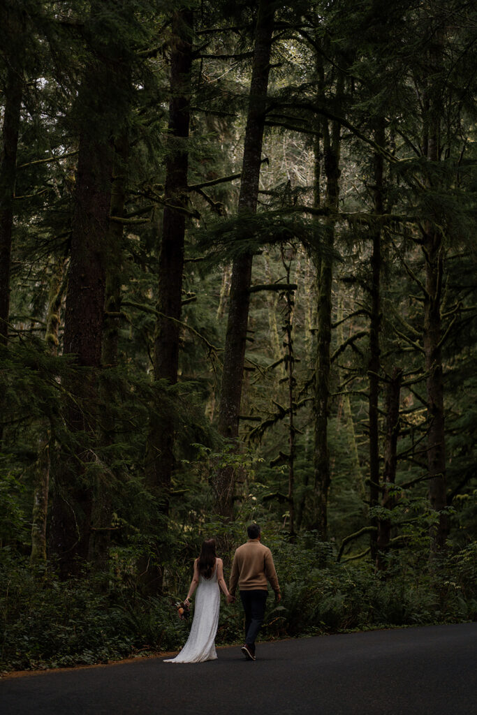 Bride and groom walk through the winding road in Ecola State Park