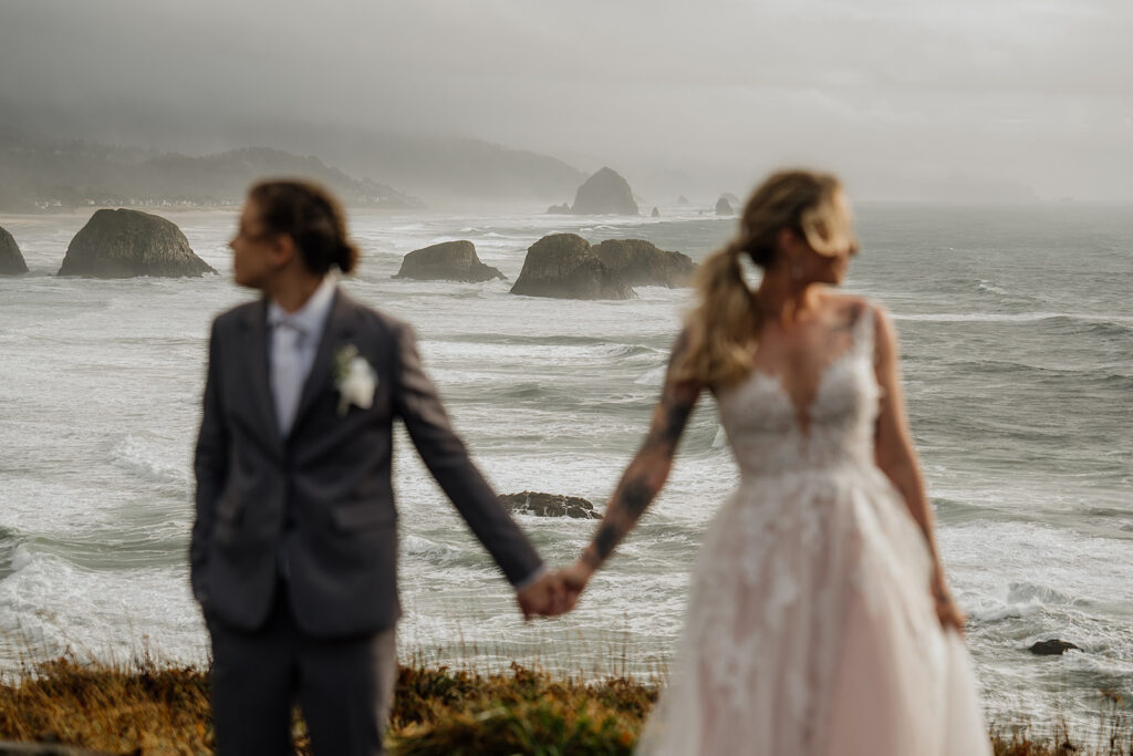Couple holds hands at the Ecola State Park Scenic Overlook
