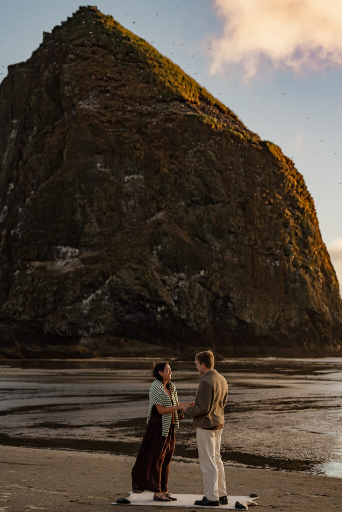 Surprise marriage proposal on Cannon Beach in front of Haystack Rock