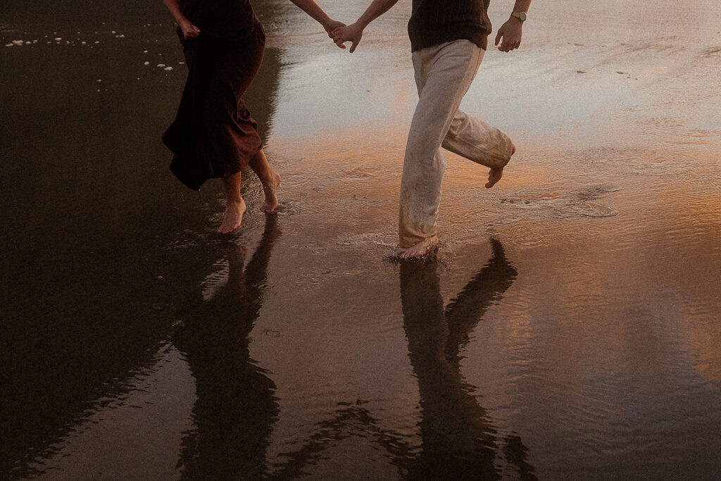 Couple runs on the beach after their surprise marriage proposal on the oregon coast