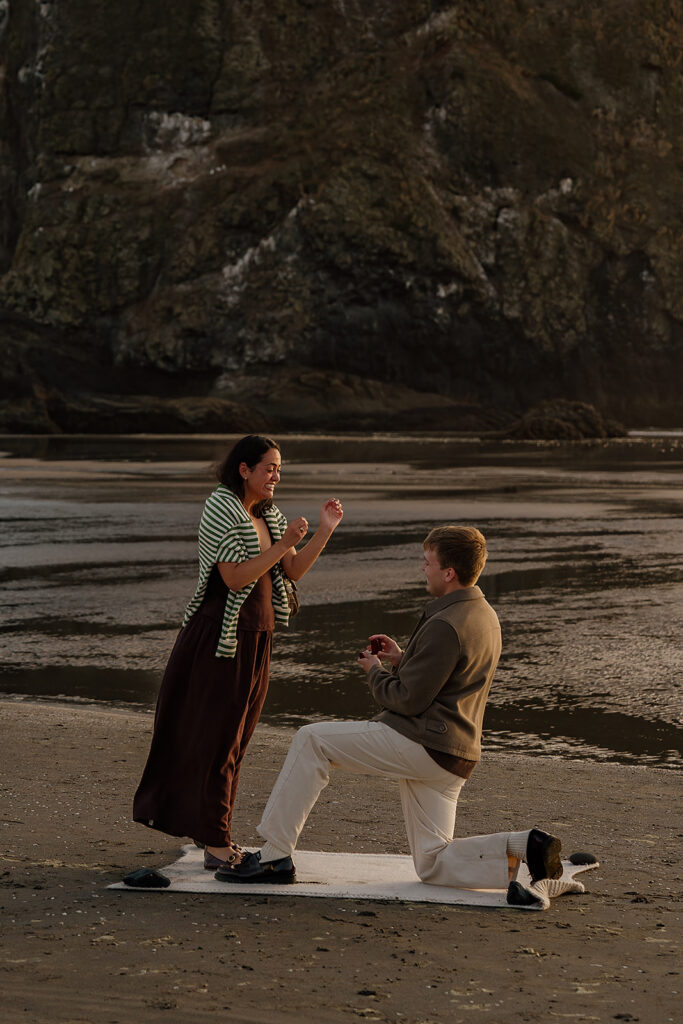 Surprise marriage proposal on Cannon Beach in front of Haystack Rock