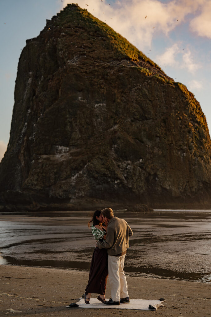 Surprise marriage proposal on Cannon Beach in front of Haystack Rock